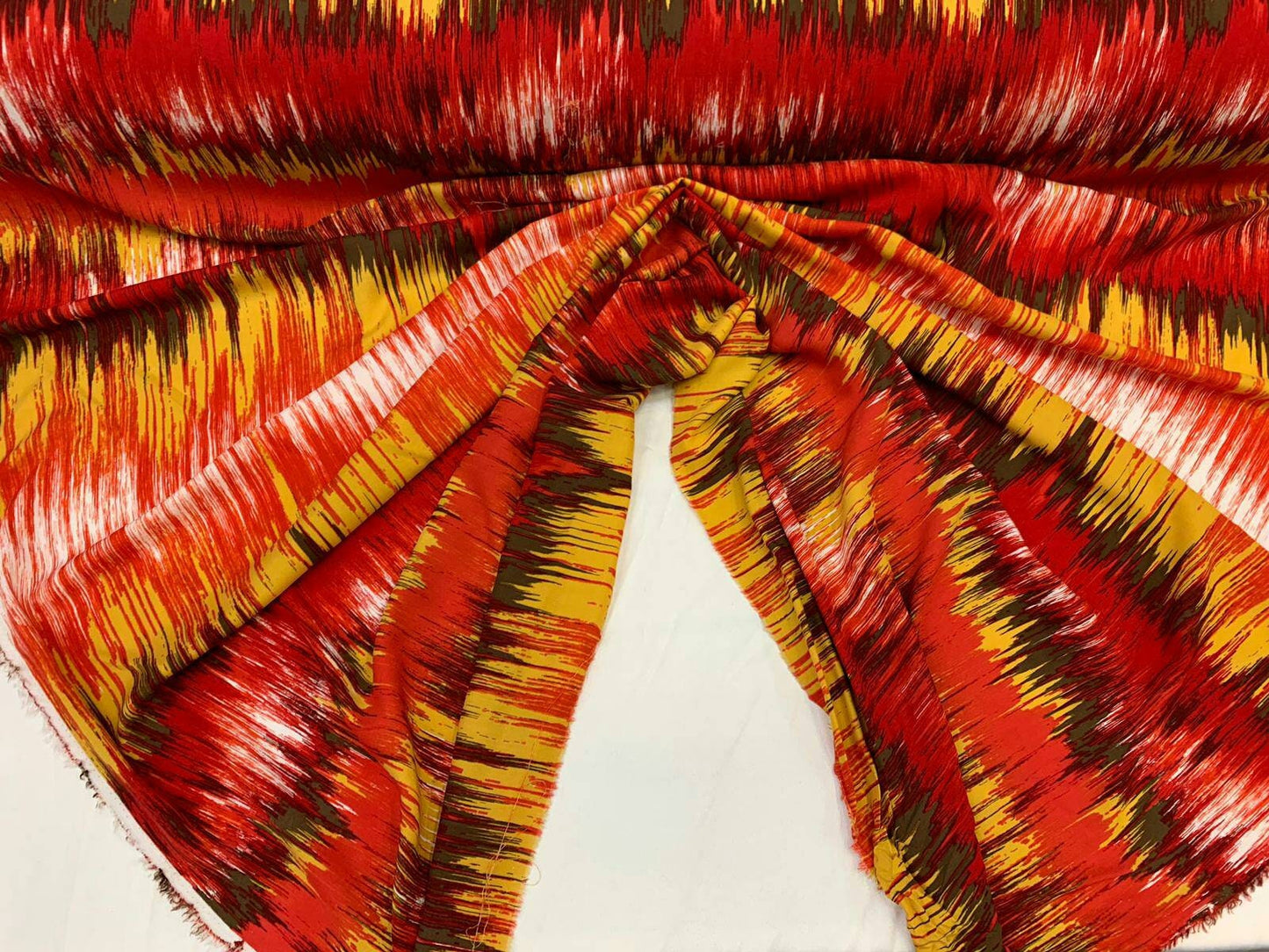 Rayon challis abstract red yellow oranges ad browns organic fabric sold by the yard dress soft flowy multicolor dress draping clothing ikat