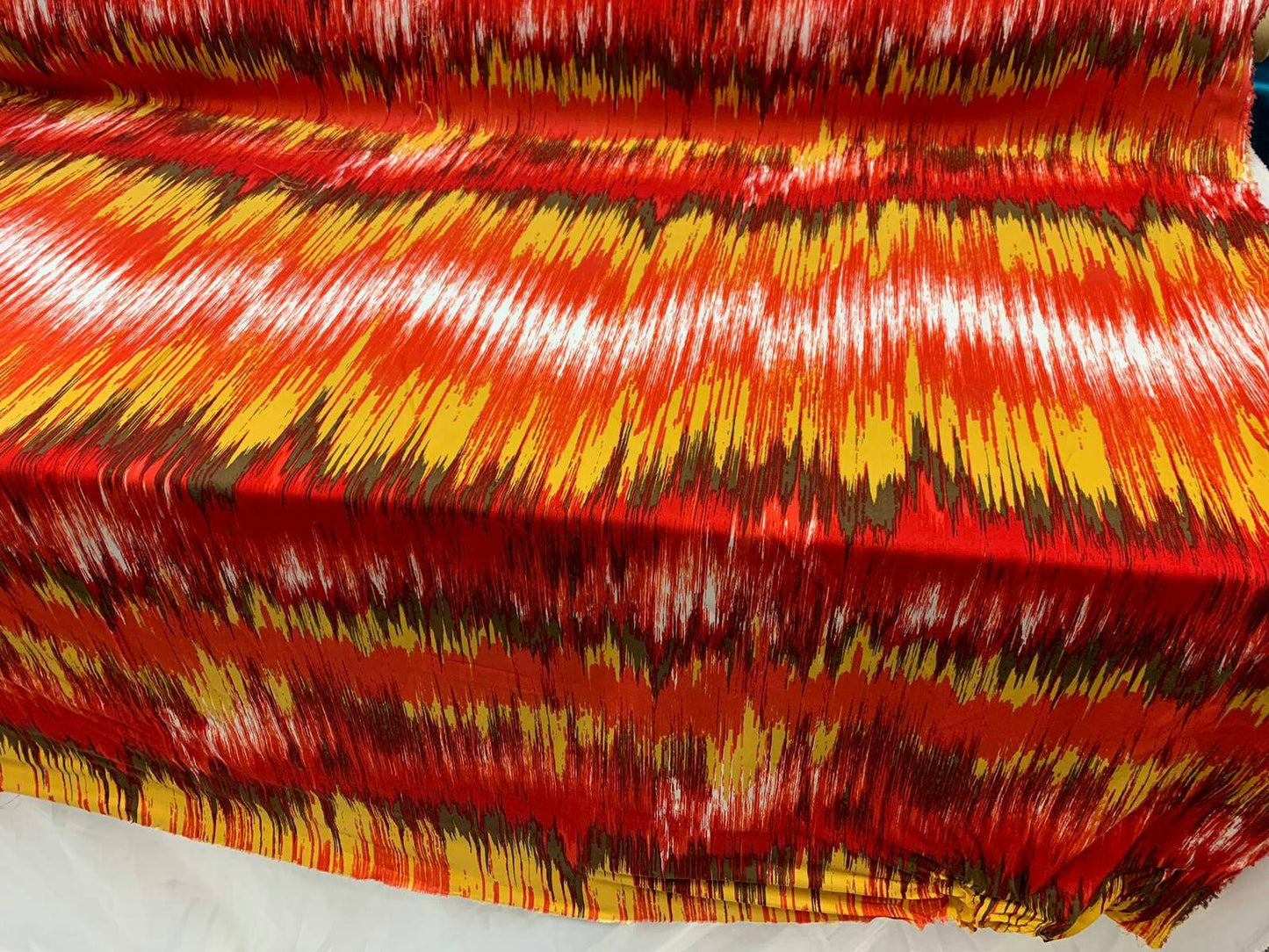 Rayon challis abstract red yellow oranges ad browns organic fabric sold by the yard dress soft flowy multicolor dress draping clothing ikat