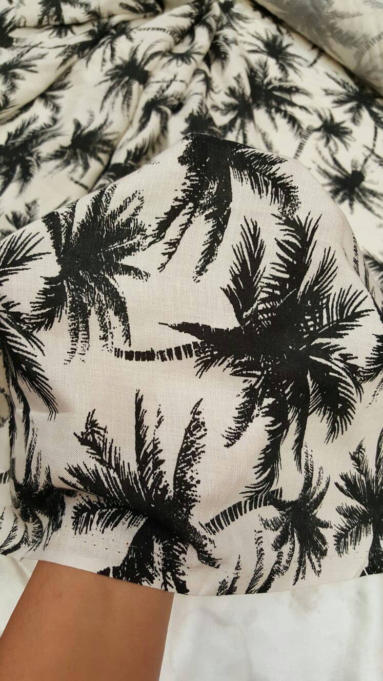 100% Rayon chally with off white background and black palmtrees