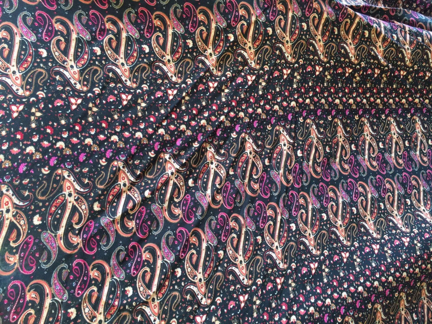 100% Rayon. Gorgeous Eurasian inspired print. Paisleys with hues of browns and fuchsia. 58-60 inches wide sold by the yard