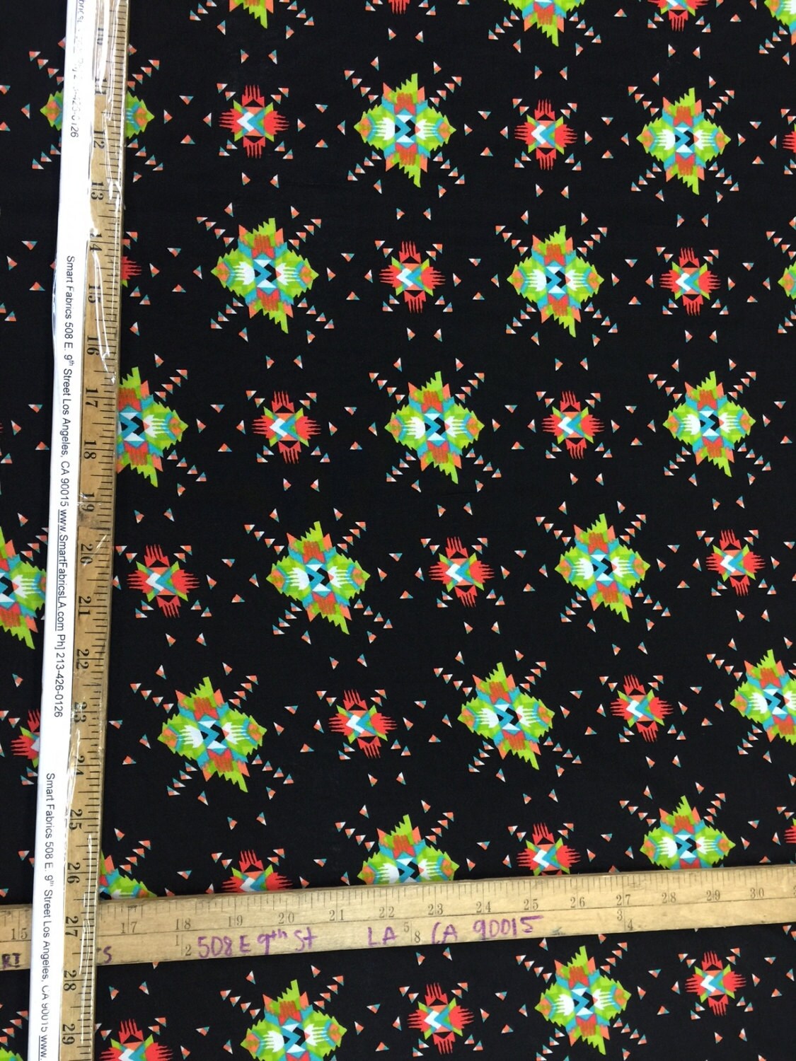 100% rayon challis. Black Native American inspired print. Fabric sold By the yard black green orange