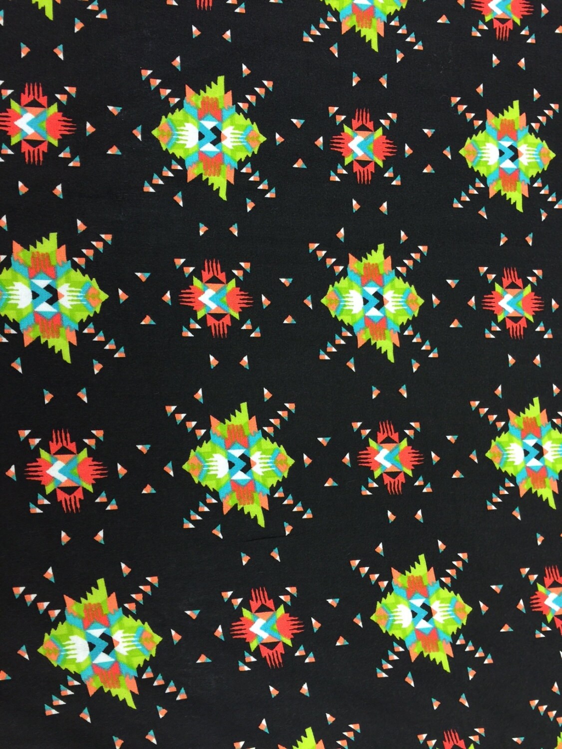 100% rayon challis. Black Native American inspired print. Fabric sold By the yard black green orange
